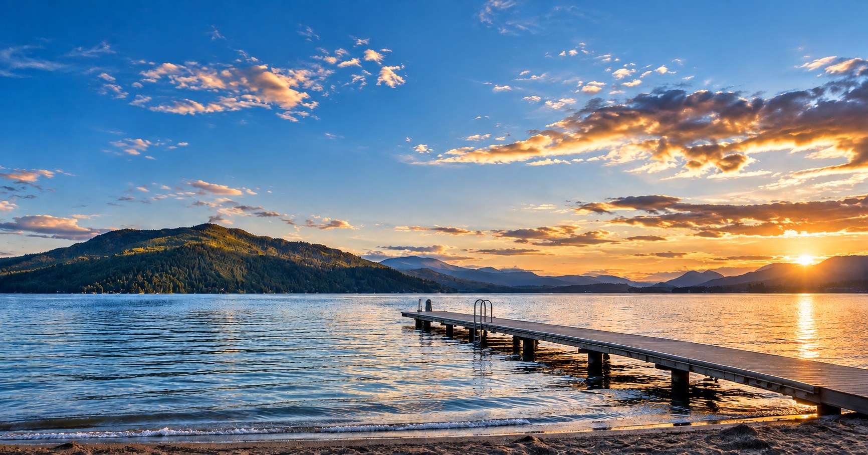 Lake Pend Oreille at sunset with a dock and North Idaho mountains